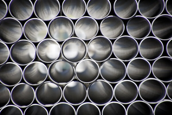 a pile of pvc pipes scheduled for delivery