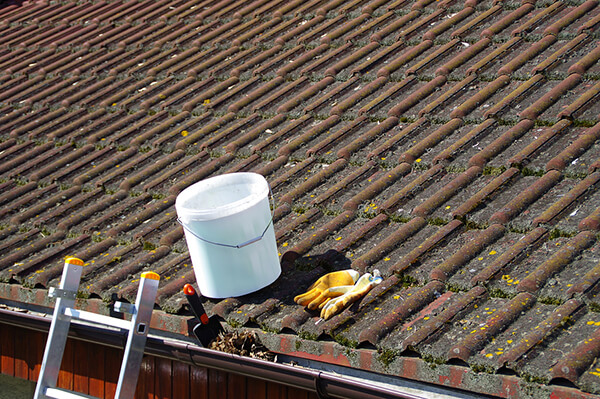 Cleaning materials above an old and dirty roof