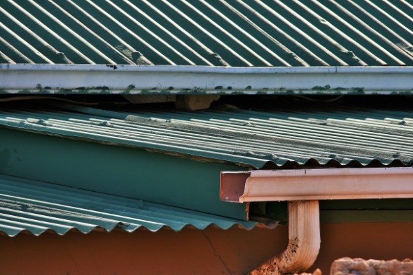 An aged corrugated metal roof and a gutter