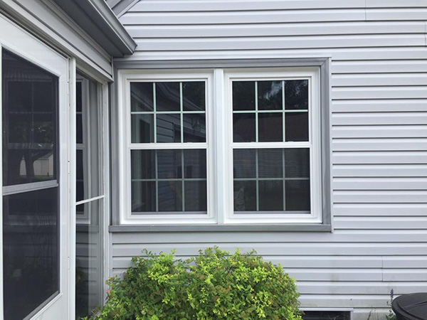 Casement windows on a home with attractive vinyl siding.